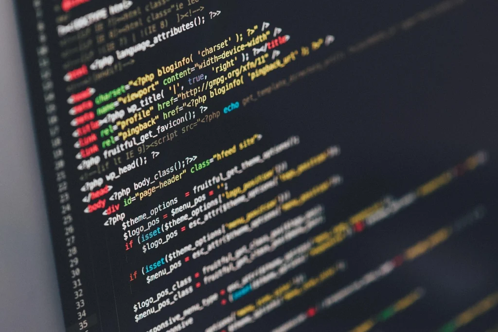 A programmer typing code on a laptop, implementing a trie for autocomplete
